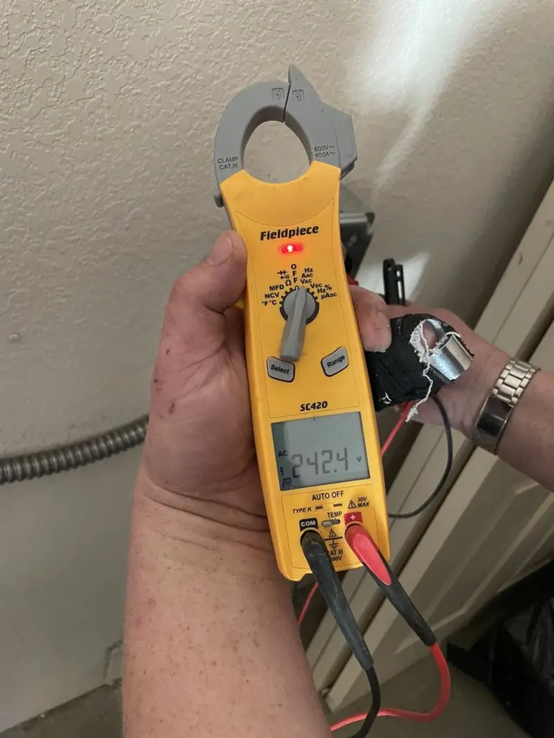 Voltage testing with clamp meter during Ceiling Fan Installation in Brandon